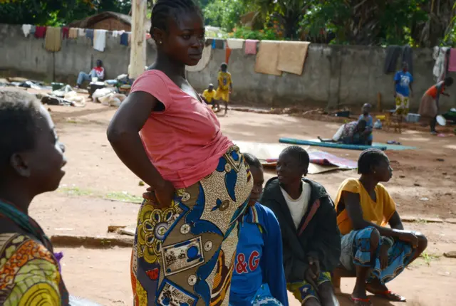 A pregnant woman stands in the courtyard of a Catholic church where residents took refuge after an ex-Seleka rebels' incursion in Bouca, on April 26, 2014.