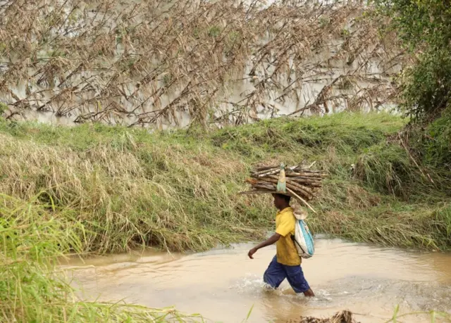 Man walking through flood waters