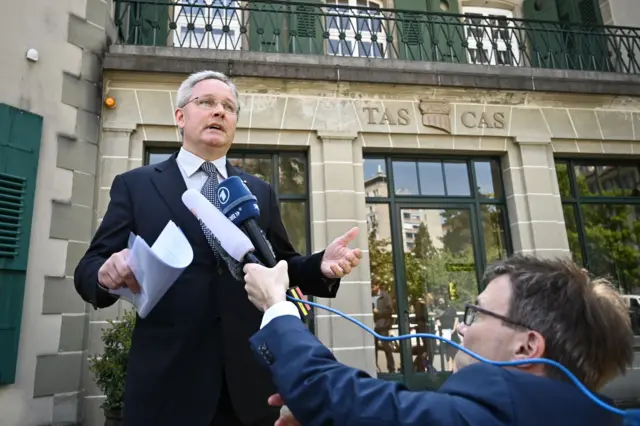 Man talking at a microphone