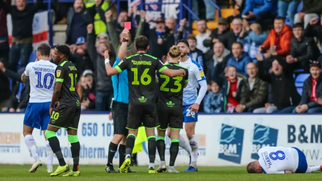 Forest Green Rovers Gavin Gunning is shown a red card
