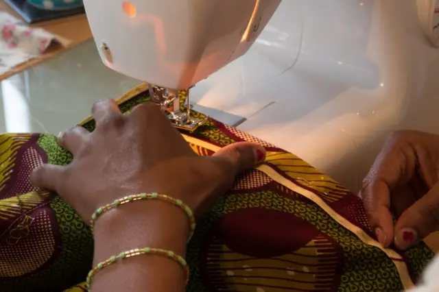 A woman at at a sewing machine