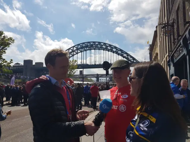 Two fans are interviewed by BBC Radio 5 Live's James Burridge