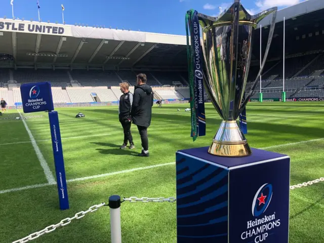 Mark McCall and Brad Barritt on the pitch in Newcastle behind the Champions Cup trophy