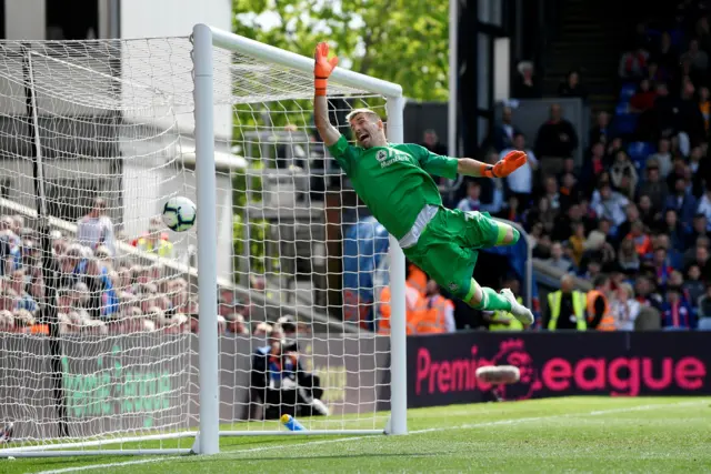 Crystal Palace goalkeeper Vicente Guaita makes a despairing dive as Jefferson Lerma shot flies past him into the net