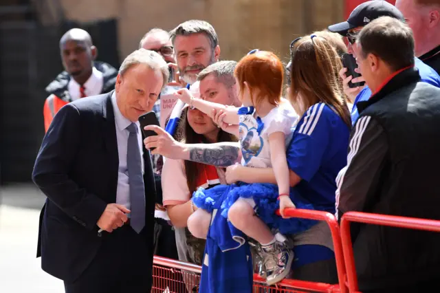 Neil Warnock poses for photos with fans