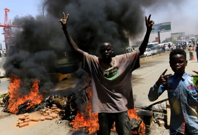 Sudanese protesters cheer as they burn tyres and barricade the road leading to al-Mek Nimir Bridge crossing over Blue Nile; that links Khartoum North and Khartoum, in Sudan May 13, 2019.