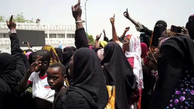 Women at a protest on April 5 gesturing to rally against the government and international forces' failure to tackle rising violence in Mali