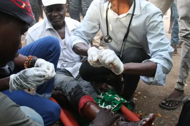 A Sudanese protester who was reportedly shot with live ammunition is treated by a paramedic on May 13, 2019 in the capital Khartoum