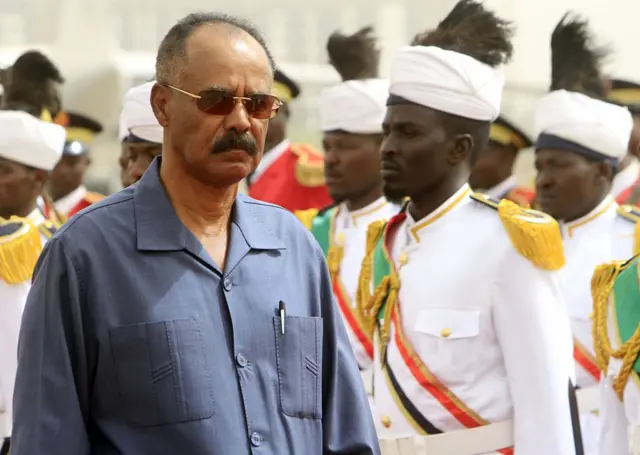 Eritrean President Isaias Afwerki (L) reviews the honor guard during his welcome ceremony in the Sudanese capital, Khartoum, on June 11, 2015