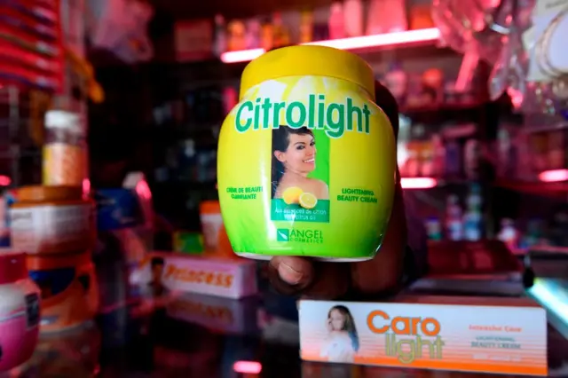 A beautician displays products used for skin lightening at a beauty shop, in Nairobi, on July 6, 2018.