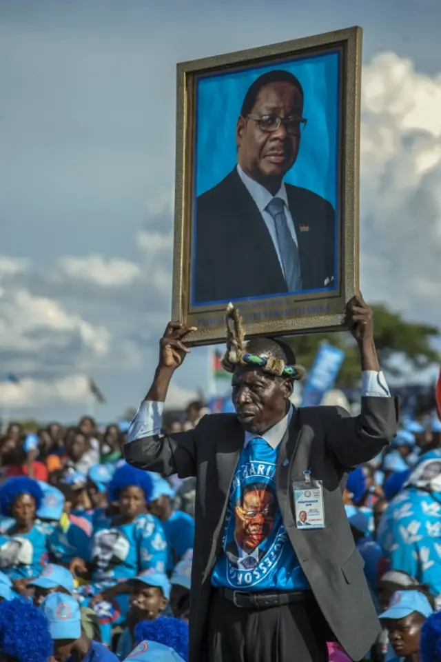 One of President Mutharika's supporters holds his portrait at a campaign in April