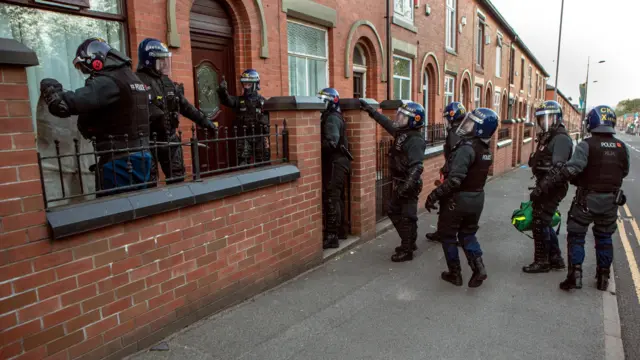 Officers raid a property