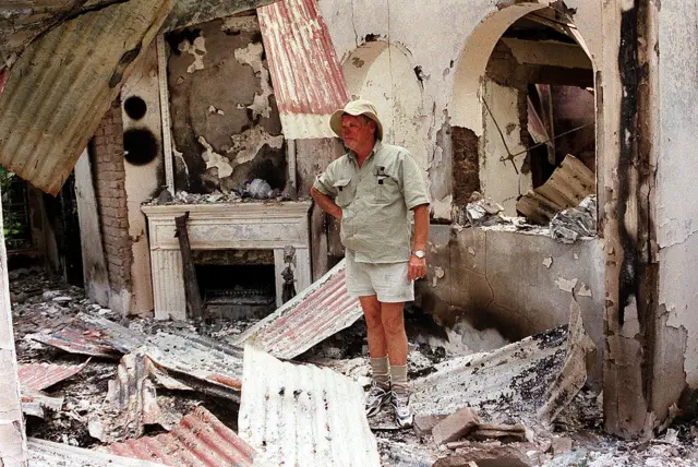 Dup Muller, 59, a commercial farmer in Headlands, 110 kilometers, (70 miles) East of Harare, shows his 17th. century clock, 11 August 2002, that was destroyed when his farm house was burnt by suspected war veterans.