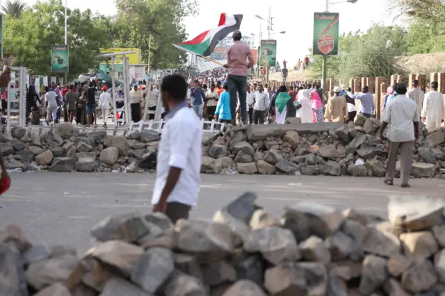 Person in front of barricades in Khartoum