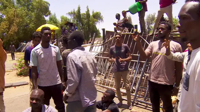 People at a barricade in Khartoum