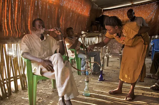 A young girl runs a restaurant cum bar, in Juba, the capital of South Sudan.