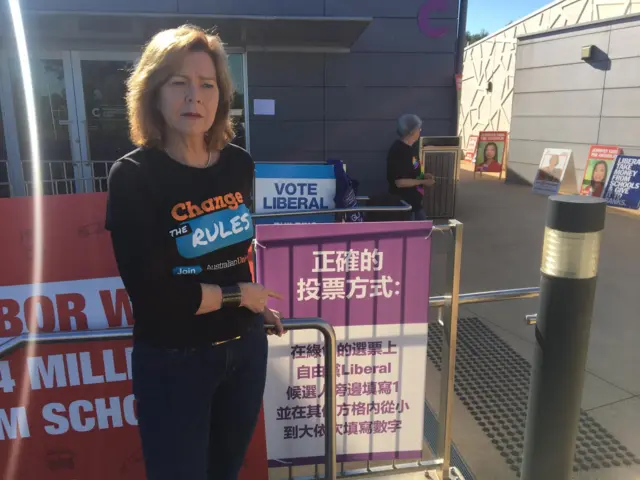 Michelle O'Neil points to one of the controversial posters in Ashwood, in the seat of Chisholm.