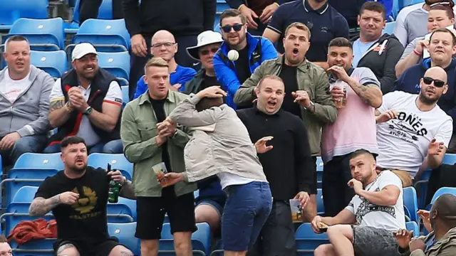 Cricket fans look scared of the ball as it is hit towards them for six runs