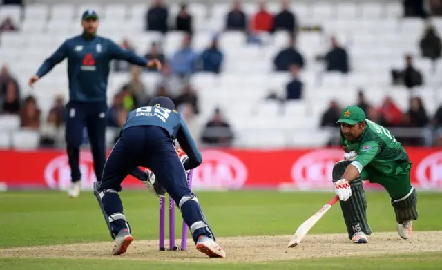 Jos Buttler of England runs out Sarfaraz Ahmed