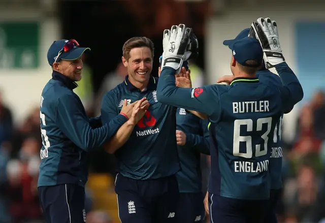 Chris Woakes (second left) celebrates after taking his fifth wicket