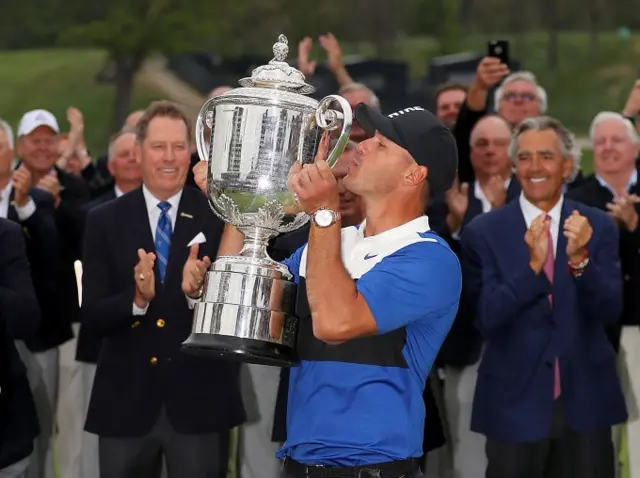 Brooks Koepka kisses the trophy