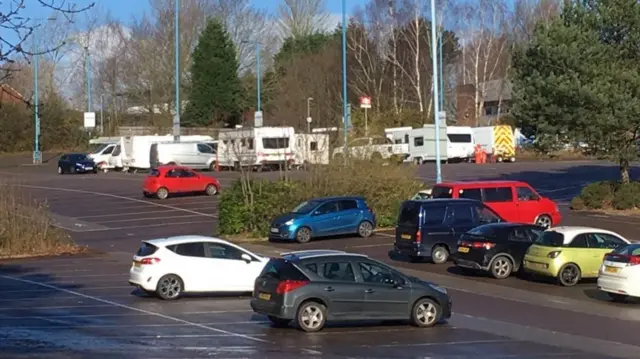 Travellers in car park