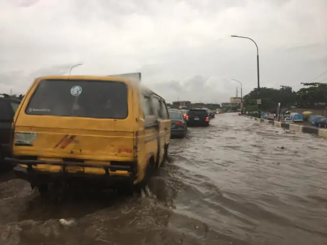 Van driving through flood waters