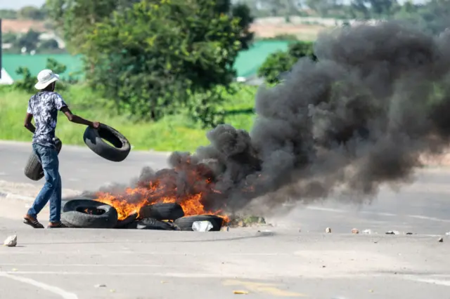 A protesters burns tyres on a road during a demonstration in Bulawayo, in January 2019.