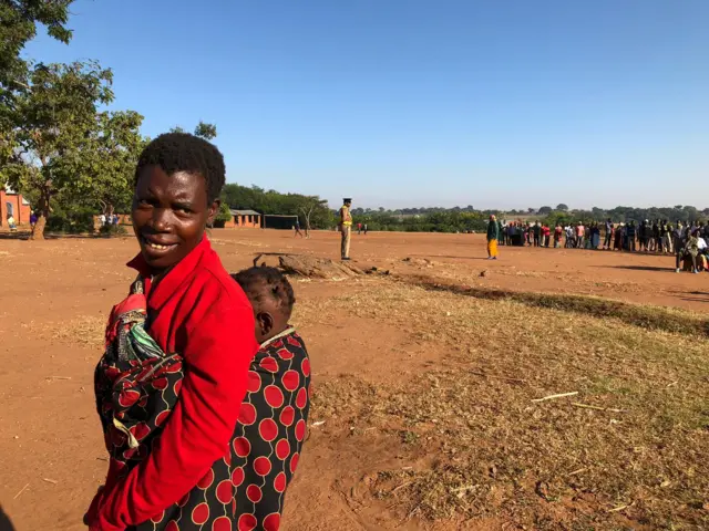 A mother with her baby on her way to cast her vote in Malawi election