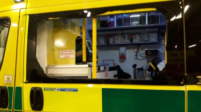 Smashed window on side of ambulance