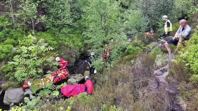 Rescuers helping the woman