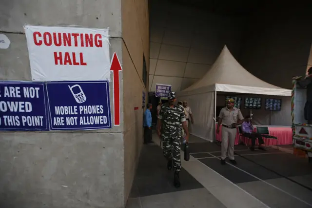 Police personnel on alert outside strong rooms near a counting hall in Delhi.