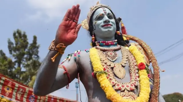 A man dressed as the Hindu god, Rama.