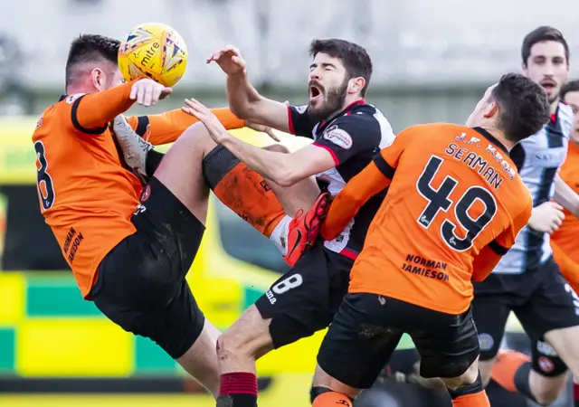 Dundee United's Calum Butcher kicks St Mirren's Ryan Flynn