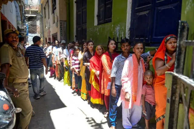 Voters queue at a polling station to cast their votes in Varanasi in Uttar Pradesh earlier this month.