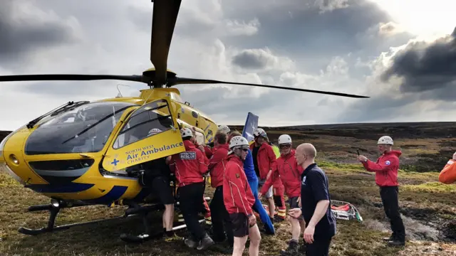 Rescuers and a helicopter