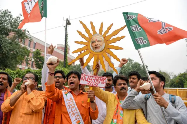 Indian Bharatiya Janata Party (BJP) supporters shout slogans as they celebrate on the vote results day at BJP headquarters in New Delhi.