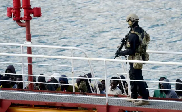 An armed policeman standds guard after migrants disembarked from the Motor Tanker El Hiblu 1 that was hijacked by migrants in Valletta's Grand Harbour on March 28, 2019, after Maltese armed forces took control of the vessel.