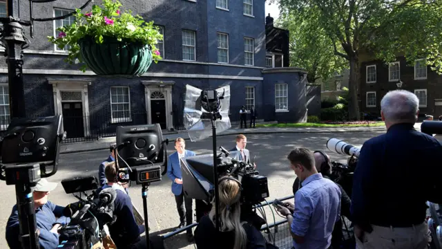 Members of the media wait in Downing Street as British Prime Minister Theresa May is expected to make a statement,