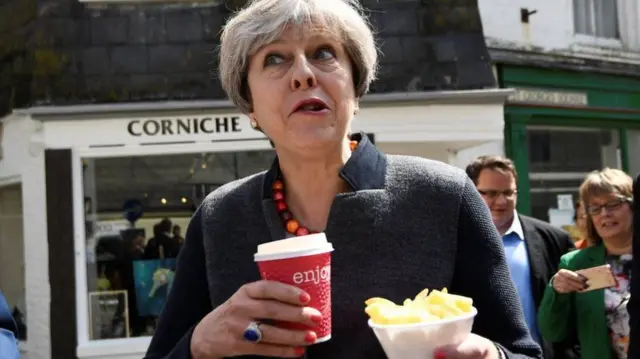 Mrs May photographed eating chips