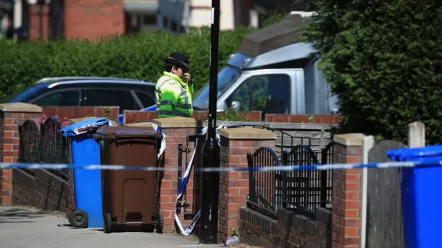 A police officer outside the house