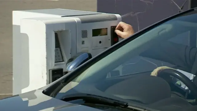 Car paying to leave airport drop-off area