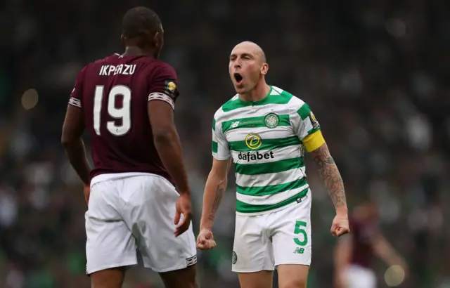 Celtic's Scott Brown has a word or Hearts' Uche Ikpeazu