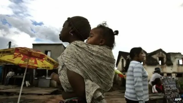 Woman with child on her back