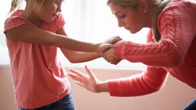 Mother smacking a child