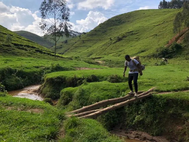 Hyppolite Ntigurirwa pictured crossing a river