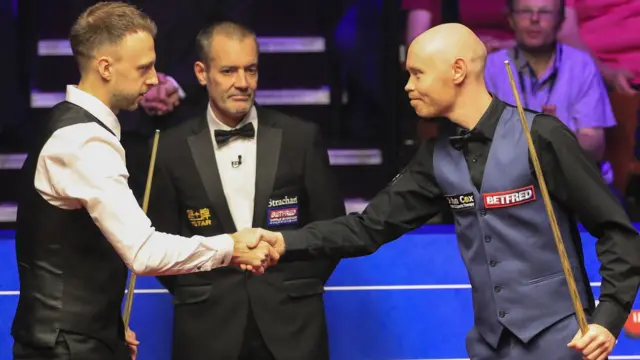 Judd Trump (left) and Gary Wilson shake hands ahead of their semi-final