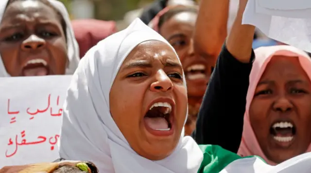 Sudanese girls chant slogans as they gather during a demonstration outside the army headquarters in Khartoum on May 2, 2019