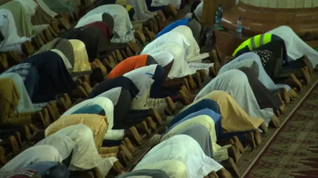 Worshippers kneel in prayer at a mosque in Nigeria