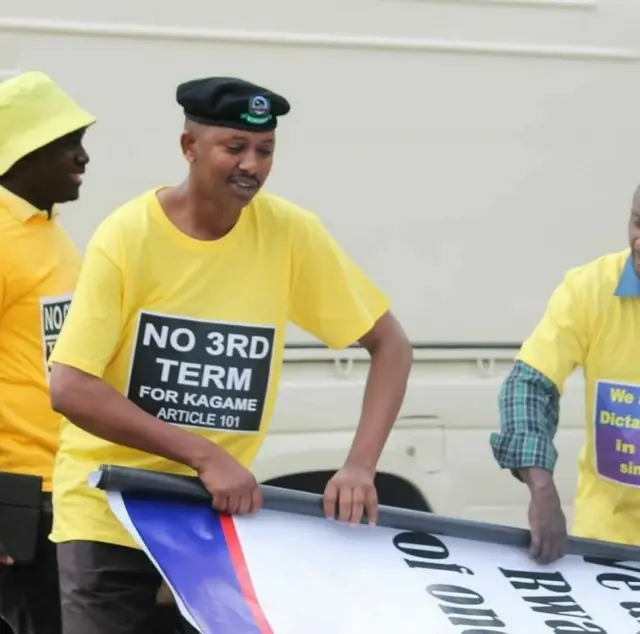 Man rolling up a banner